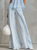 Light blue striped chiffon wide-leg women's pants by FJØRNA with flowing fabric and relaxed fit.
