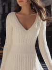 Cream cable knit V-neck flare hem sweater dress by FJØRNA, featuring a cozy mini dress design with a stylish flare hem.