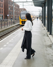 FJØRNA women's high-waisted wide-leg summer trousers with button front and breathable fabric, styled for a casual look.