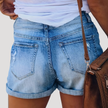 FJØRNA women's lightweight summer shorts with high waist and button front, shown in a casual outdoor setting.
