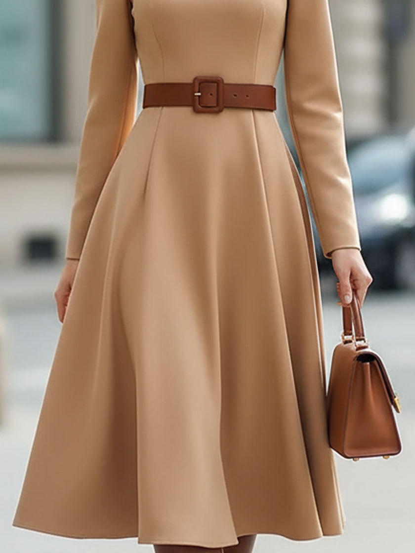 Elegant camel turtleneck belted midi dress by FJØRNA, featuring a fitted silhouette and stylish design, displayed on a dress form.