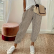 FJØRNA women's lightweight summer trousers with wide-leg design and vertical stripes, perfect for casual warm-weather wear.