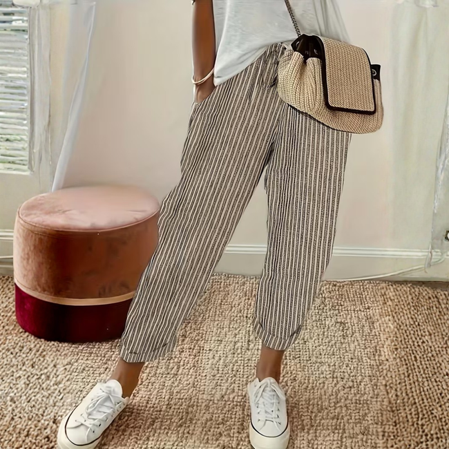 FJØRNA women's lightweight summer trousers with wide-leg design and vertical stripes, perfect for casual warm-weather wear.