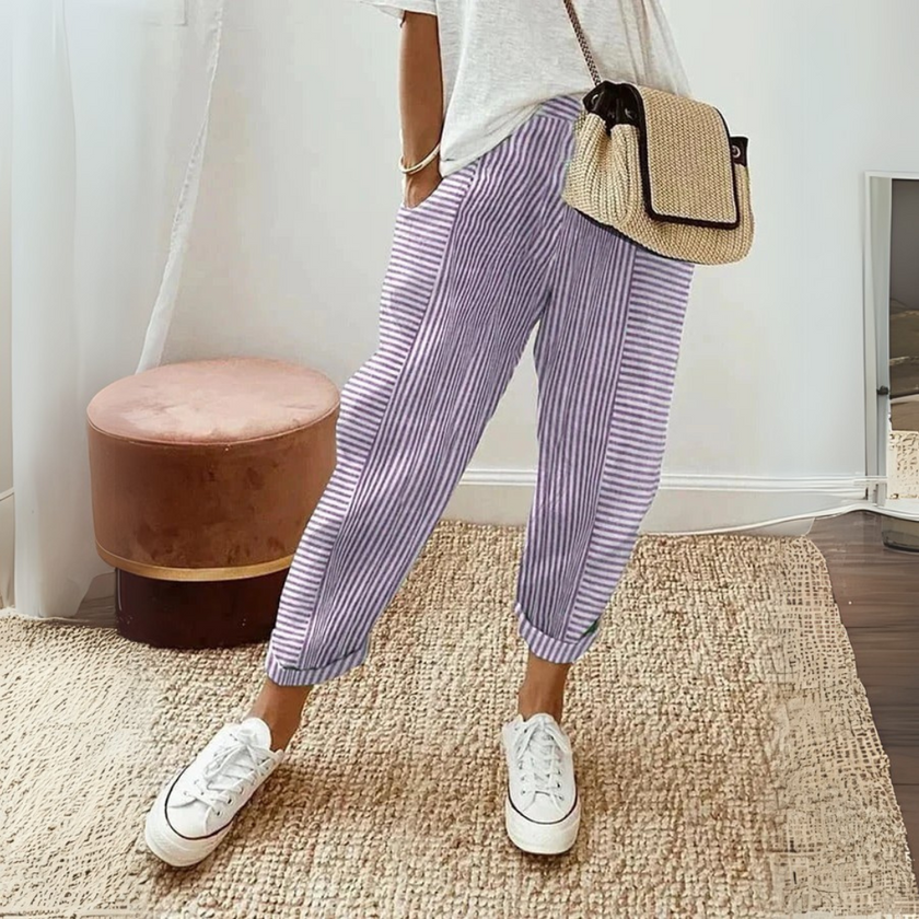 FJØRNA lightweight women's wide-leg striped summer trousers, casual and breathable for warm weather, shown in natural fabric detail.