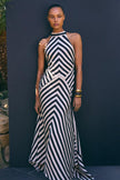 FJØRNA Mono Fluid Stripe Maxi Halter Dress in white, featuring a flowy design and halter neckline, perfect for summer occasions.