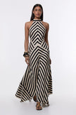 FJØRNA Mono Fluid Stripe Maxi Halter Dress in white, flowing fabric, sleeveless design, and elegant halter neckline.