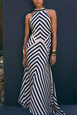 FJØRNA Mono Fluid Stripe Maxi Halter Dress in white, flowing fabric with halter neckline, stylish and elegant for summer occasions.