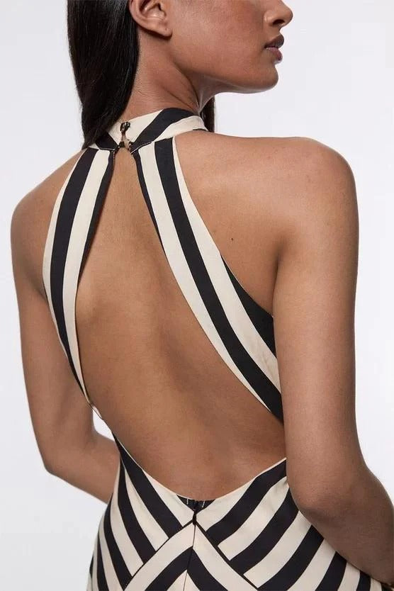 FJØRNA Mono Fluid Stripe Maxi Halter Dress in white, featuring a flowing design and halter neckline, perfect for summer occasions.
