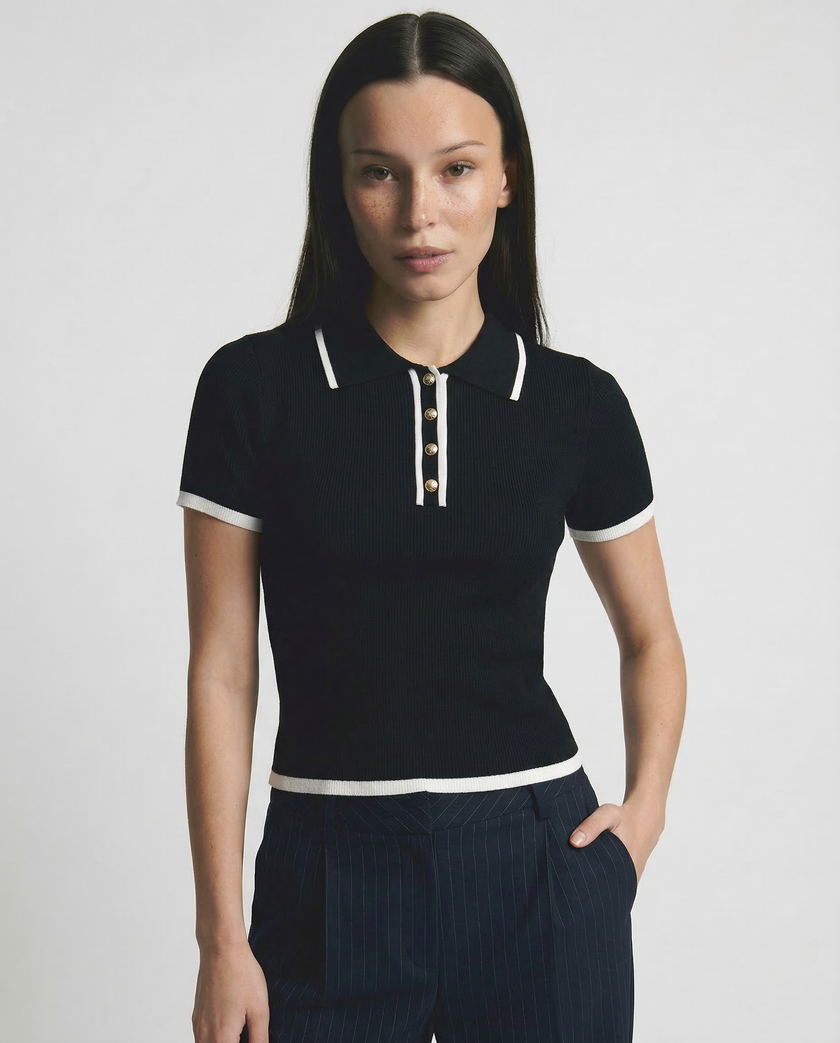 Black cotton polo top for women by FJØRNA, featuring a classic polo shirt design and a comfortable fit.