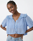 Cream cropped cotton blouse with lace trim, women's FJØRNA top featuring a stylish, feminine design and lightweight fabric.