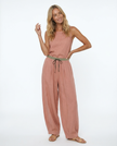 FJØRNA women's linen tapered trousers, lightweight and comfortable pants, shown on a model with a relaxed fit and neutral color.