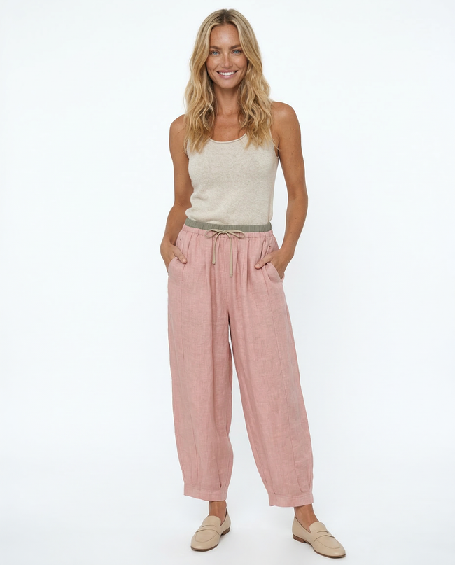 FJØRNA women's linen tapered trousers, stylish and comfortable pants with a relaxed fit, shown in natural fabric detail.