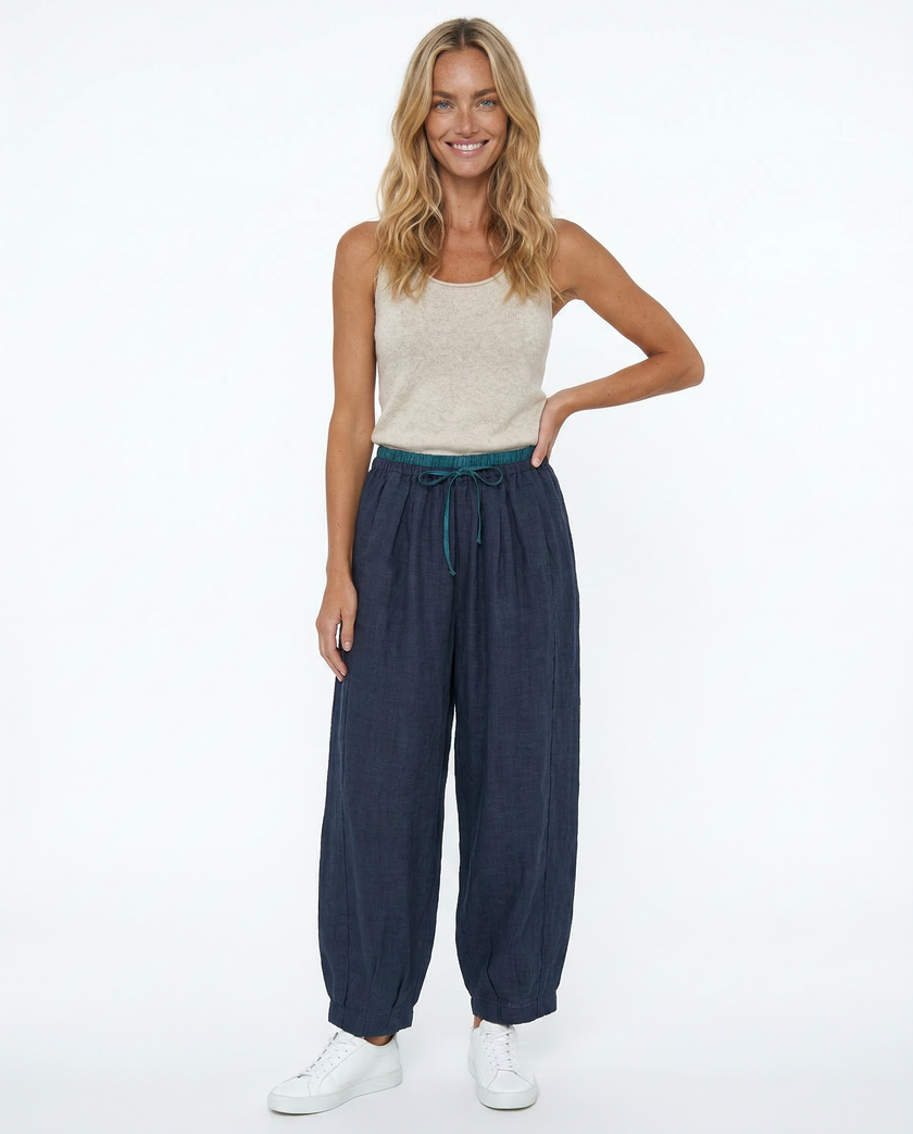 FJØRNA women's linen tapered trousers, lightweight and comfortable pants with a relaxed fit, displayed on a neutral background.