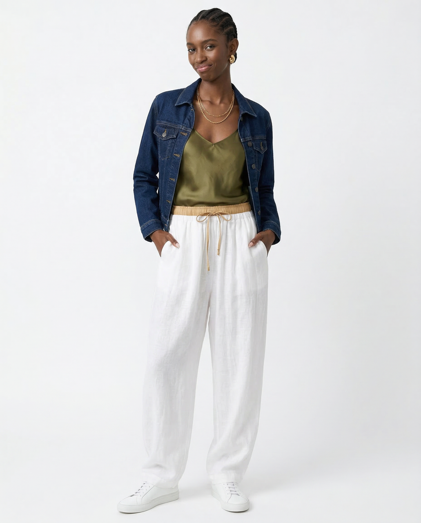 FJØRNA women's linen tapered trousers, lightweight pants with a relaxed fit and natural fabric, shown in a neutral color.