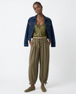 FJØRNA women's linen tapered trousers, stylish and comfortable pants for women, shown in natural fabric detail and relaxed fit.