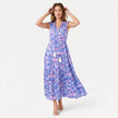 Women's sleeveless floral print boho maxi dress with tie neck from FJØRNA, featuring a flowing silhouette and vibrant floral pattern.