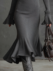 FJØRNA women's knit midi dress shown in a cozy, fitted style with long sleeves and a round neckline.