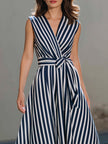 FJØRNA navy sleeveless wrap midi dress with vertical stripe pattern, elegant and stylish for versatile occasions.