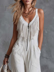 White faux suede Western fringe V-neck jumpsuit for women by FJØRNA, featuring fringe details and a stylish V-neck design.