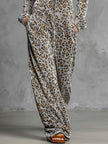 Grey velvet leopard print hooded wide-leg jumpsuit for women, stylish FJØRNA pants with relaxed fit and trendy animal pattern.