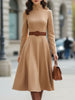 FJØRNA elegant camel turtleneck belted midi dress, showcasing a stylish long-sleeve dress with a waist belt and midi length.