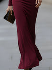 FJØRNA burgundy long-sleeve draped cutout evening gown with elegant design, perfect for formal black-tie events.