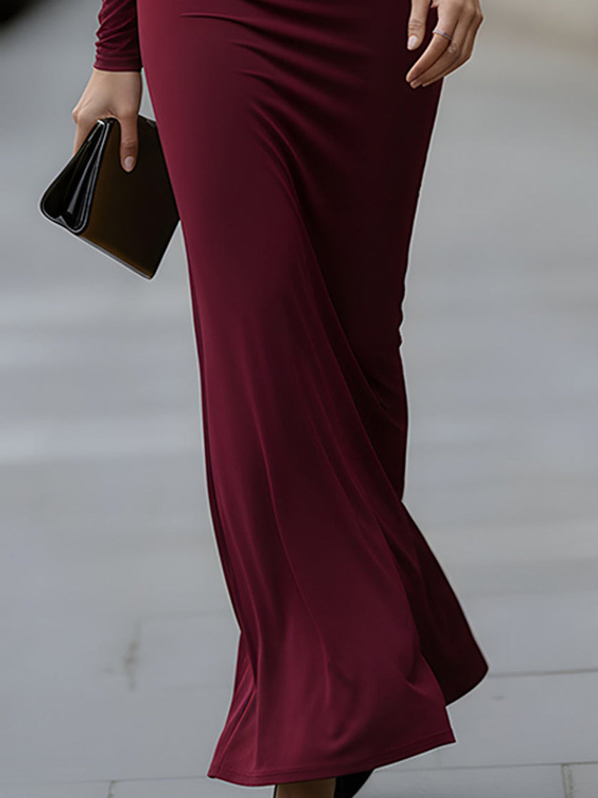 FJØRNA burgundy long-sleeve draped cutout evening gown with elegant design, perfect for formal black-tie events.