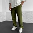 Men's relaxed knit trousers in khaki by FJØRNA, featuring a comfortable fit and casual style.