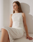 Red pearl-strap textured midi dress by FJØRNA, featuring water ripple pattern and elegant design, worn by a woman.