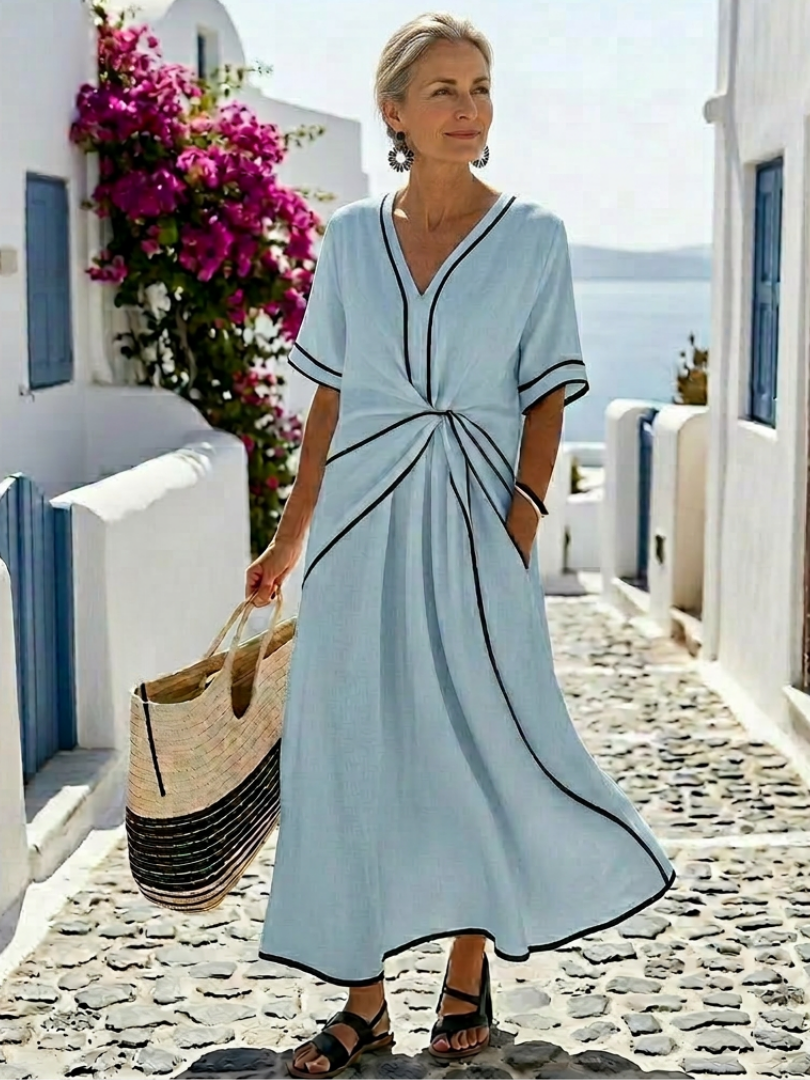 FJØRNA women's summer midi dress with short sleeves, wrap design, flowy and breathable fabric, perfect for warm weather.
