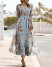 Blue FJØRNA midi dress for women with lapel collar and printed design, shown on a model.