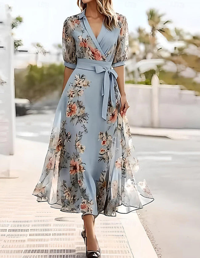 Blue FJØRNA midi dress for women with lapel collar and printed design, shown on a model.