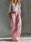 Pink cotton linen wide-leg dungarees for women by FJØRNA, shown on a model with adjustable shoulder straps and relaxed fit.