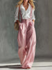 Pink cotton linen wide-leg dungarees for women by FJØRNA, shown on a model with adjustable shoulder straps and relaxed fit.