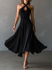 Black FJØRNA halter neck midi dress, elegant evening dress with fitted bodice and flowing skirt, showcased on model.