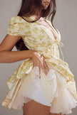 FJØRNA Emily Floral V-neck corset mini dress in white, featuring a fitted bodice and floral print, perfect for summer wear.