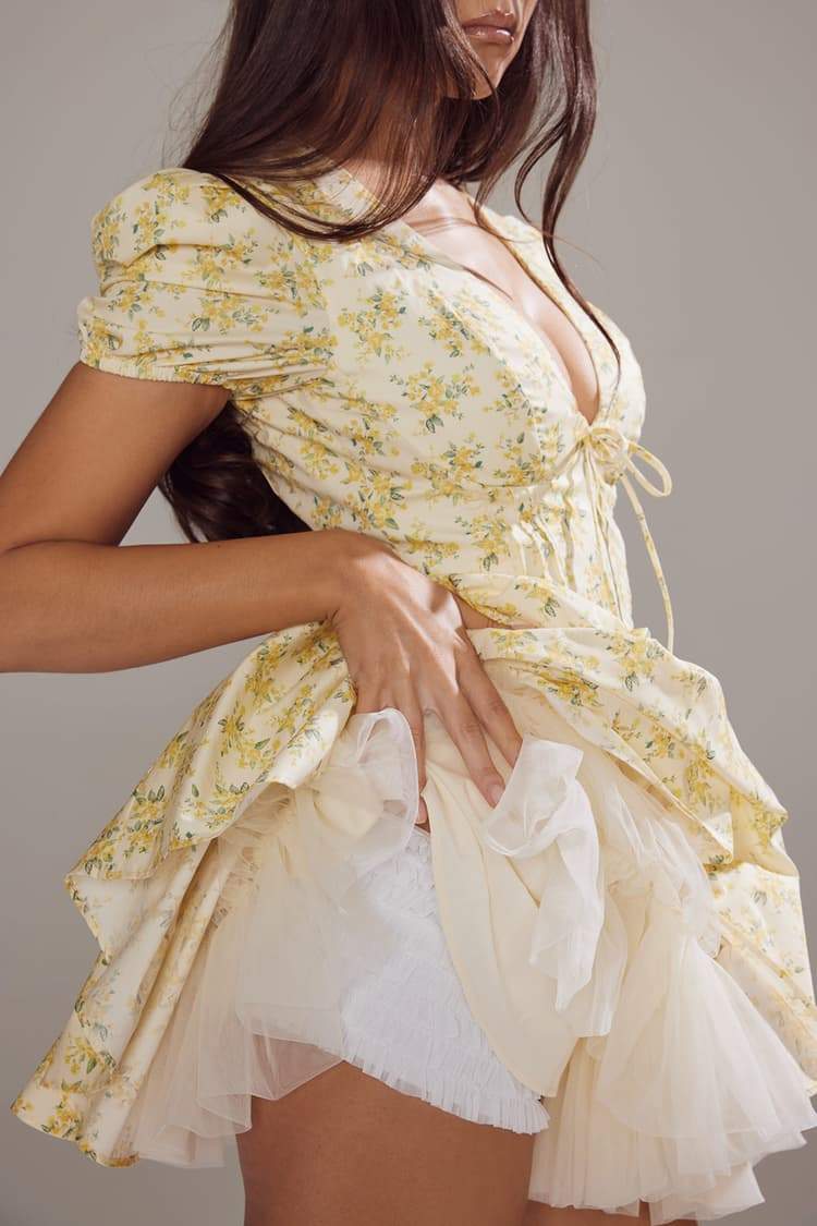 FJØRNA Emily Floral V-neck corset mini dress in white, featuring a fitted bodice and floral print, perfect for summer wear.