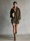 Woman wearing a loose suede mini dress by FJØRNA, showcasing the dress's soft texture and stylish fit.