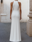 White satin pleated halter evening gown by FJØRNA featuring elegant design for formal black tie events.