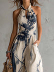 White ink wash print halter neck wide-leg jumpsuit with pockets for women by FJØRNA, showcasing a stylish, comfortable design.