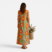 Women's floral maxi dress by FJØRNA featuring a relaxed boho style with vibrant floral patterns and flowing fabric.