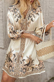 FJØRNA champagne mini dress with printed V-neck, lantern sleeves, and waist tie, perfect for stylish occasions.