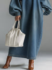 Blue denim maxi dress by FJØRNA, flowing evening dress with long sleeves and a relaxed fit, shown on a model.