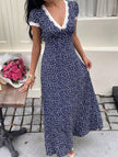 White lace patch floral V-neck maxi dress by FJØRNA with intricate lace details and flowing fabric, perfect for elegant occasions.
