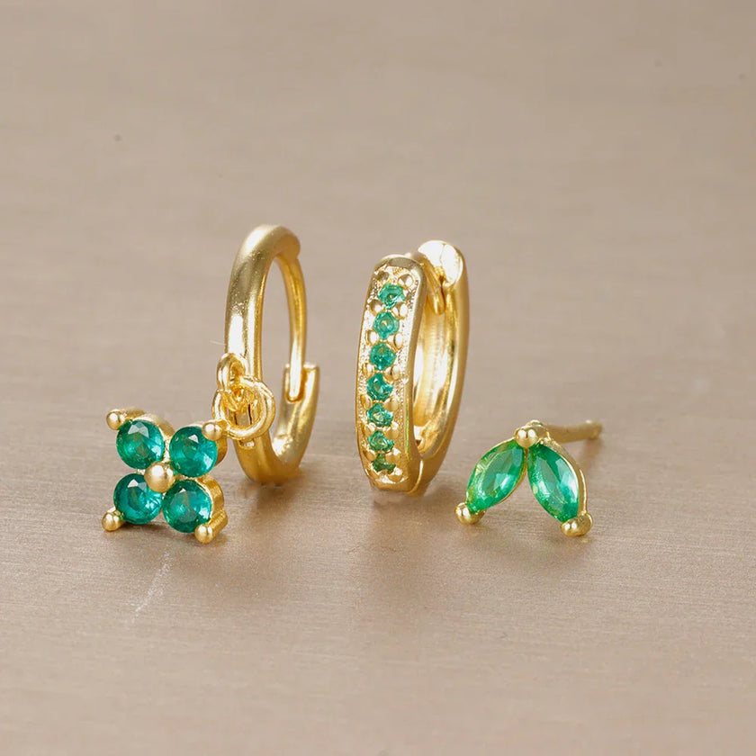 FJØRNA unisex minimalist piercing set with stainless steel hoops and studs in gold, green, and hazel, stylish and comfortable accessories for women.
