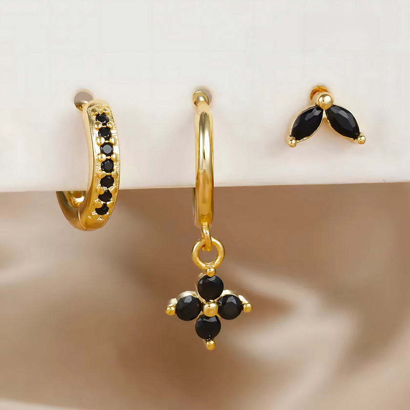 Unisex minimalist piercing set by FJØRNA featuring gold and green stainless steel hoops and studs for women.