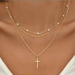 Gold 3-layer pearl pendant necklace set for women by FJØRNA, featuring layered gold and silver necklaces with heart and cross pendants.