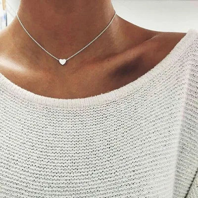 Gold 3-layer pearl pendant necklace set for women by FJØRNA, featuring layered gold and silver necklaces with heart and cross pendants.