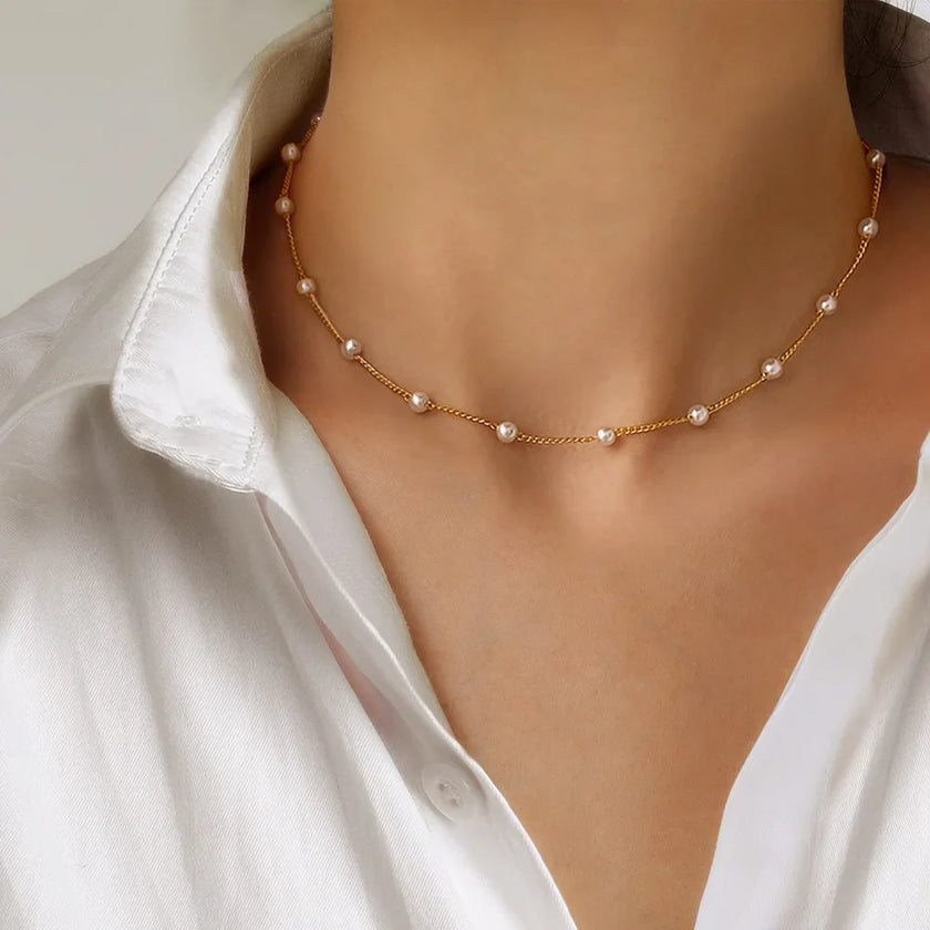 Gold 3-layer pearl pendant necklace set for women by FJØRNA, featuring layered gold and silver necklaces with heart and cross pendants.