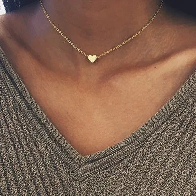 Gold 3-layer pearl pendant necklace set for women by FJØRNA, featuring layered gold and silver necklaces with heart or cross pendants.